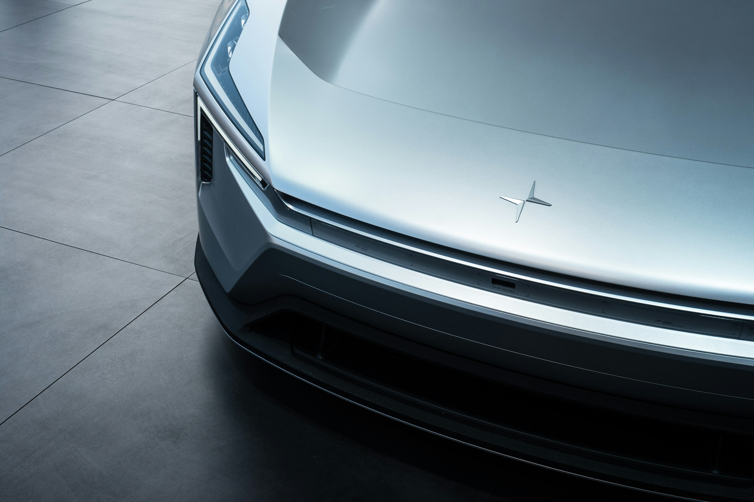 Close crop of the nose and emblem of a silver Polestar